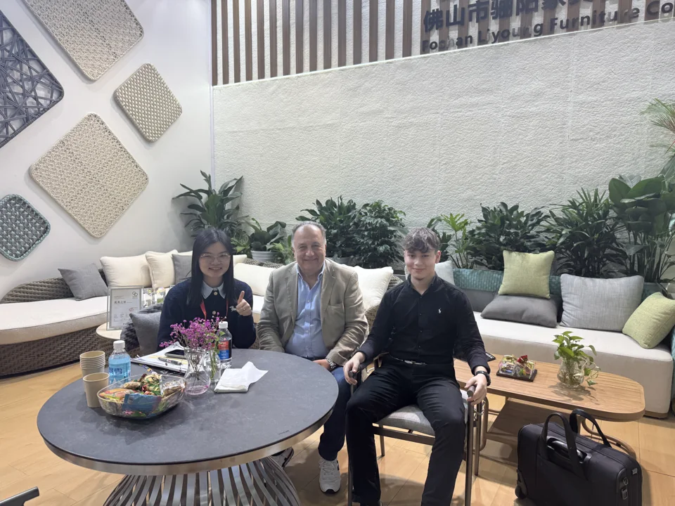 Visitors seated around showroom furniture